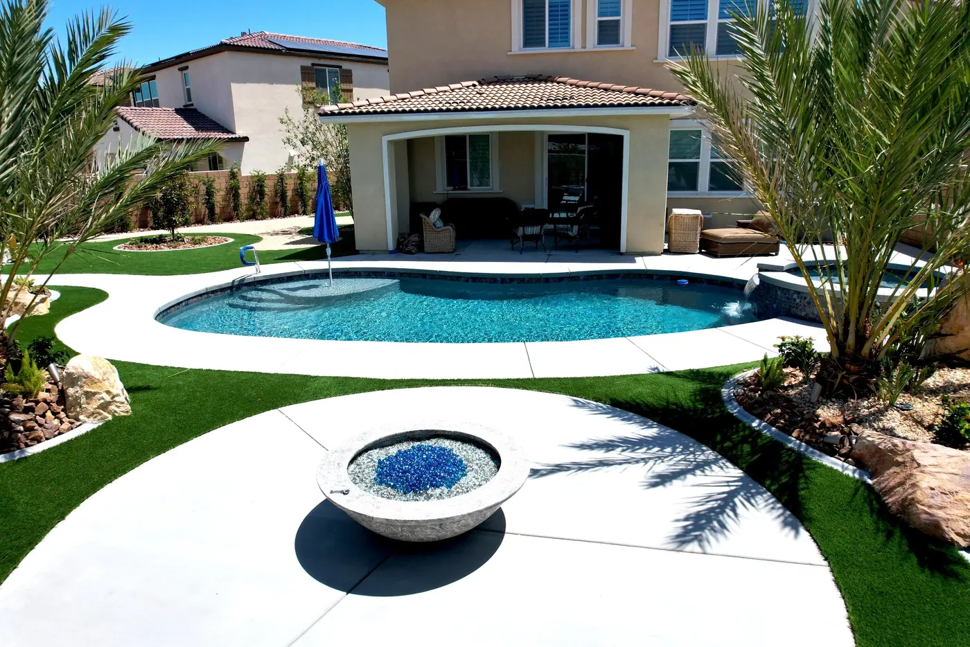 Pool with a fire bowl and palms from above