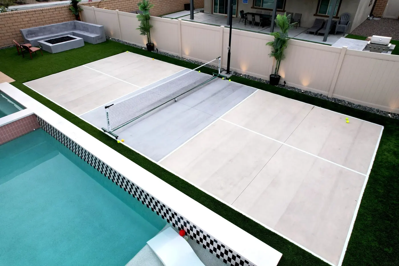 Aerial of a backyard court and pool