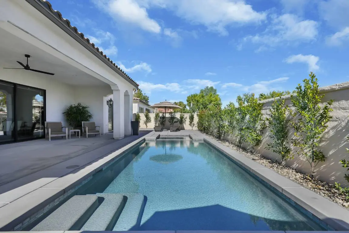 Long narrow lap pool beside a modern home
