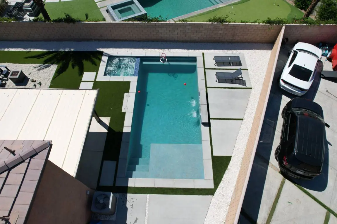Aerial of a narrow modern pool in a compact yard