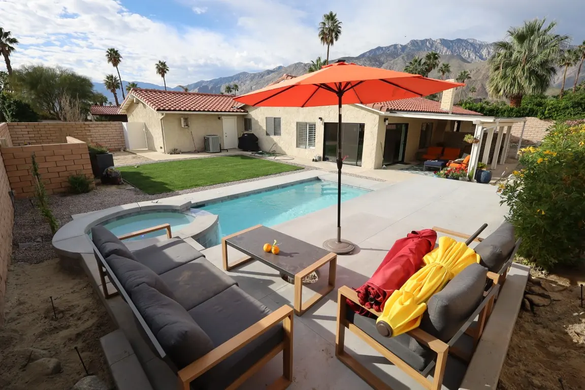 Patio with lounge furniture, umbrella and pool